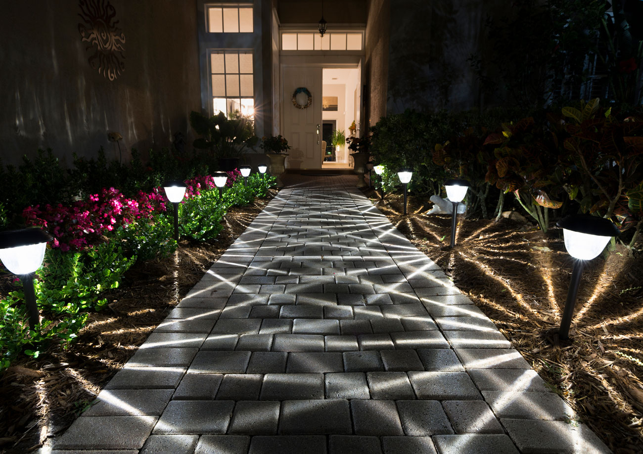 Landscape lighting creating curb appeal on a home exterior at night